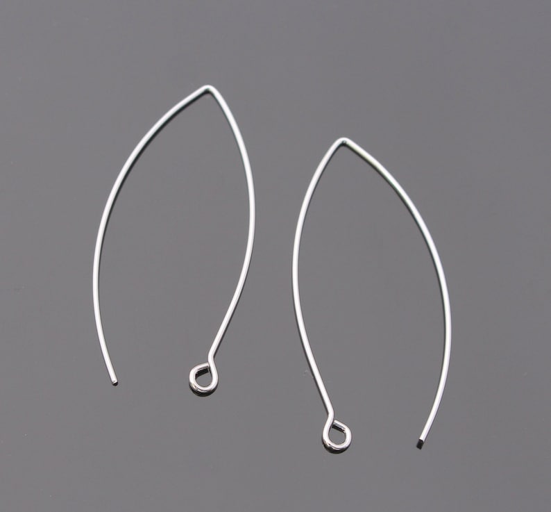 May include: Two silver wire earring hoops with a small loop at the bottom.