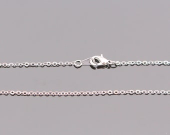 May include: A silver chain necklace with a lobster clasp closure.
