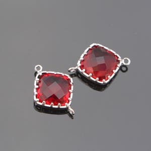 May include: Two silver-toned metal charms with red square-shaped glass stones. The stones have a faceted design.