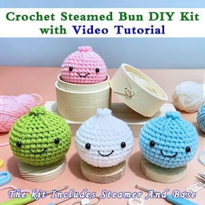 May include: A DIY crochet kit for making steamed buns, with a video tutorial. The kit includes four colourful, smiling, crocheted buns in pink, green, white, and blue, and a bamboo steamer. The text reads: "Crochet Steamed Bun DIY Kit with Video Tutorial."