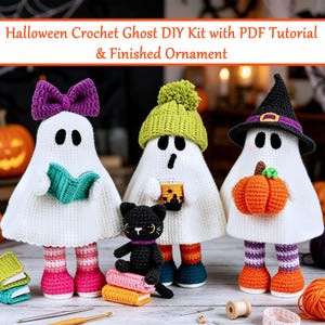 May include: Three white crochet ghost ornaments with accessories. One wears a purple bow, one a green beanie holding a drink, and one a black witch hat holding an orange pumpkin. A small black cat sits on books. Text reads: Halloween Crochet Ghost DIY Kit with PDF Tutorial & Finished Ornament.
