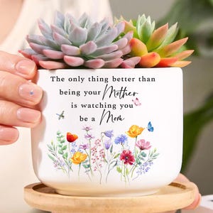 May include: A set of three ceramic mugs with a speckled, matte finish. The mugs are in shades of cream, light gray, and dark gray. Each mug has a simple, minimalist design, perfect for coffee or tea.