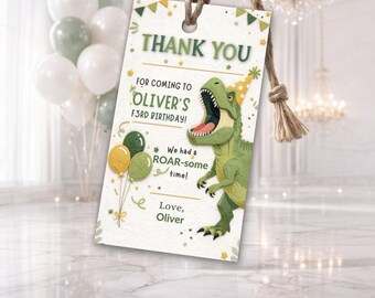 May include: A rectangular gift tag with a dinosaur theme. The tag reads "THANK YOU" and "FOR COMING TO OLIVER'S F3RD BIRTHDAY!". A green dinosaur illustration is featured, along with balloons and the text "We had a ROAR-some time!" and "Love, Oliver".