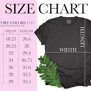 May include: A size chart for Comfort Colors 1717 unisex heavyweight tees. The chart lists sizes S to 4XL with corresponding width and length measurements in inches. A dark gray t-shirt is shown with a sprig of green leaves.