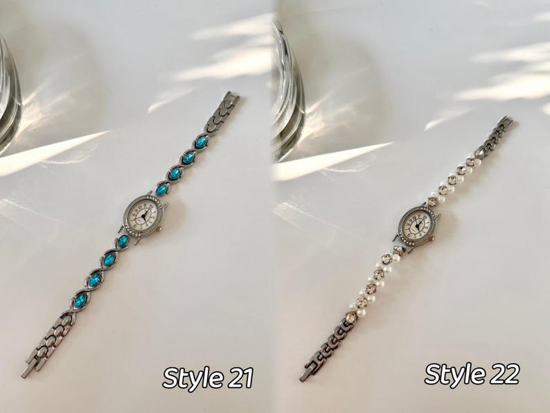 May include: Two elegant women's watches. Style 21 features a silver band with oval turquoise stones. Style 22 has a silver band with white pearls. Both watches have a round, silver watch face with a white background and black hands.