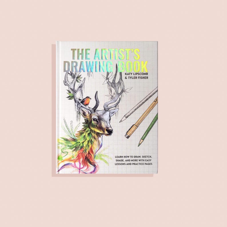 The Artists Drawing Book cover is white with iridescent lettering. There's a dear sketch on the front with pencils and pens.