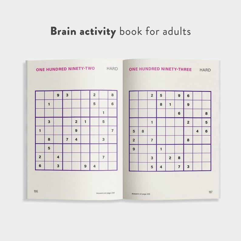 May include: An open brain activity book for adults, featuring two Sudoku puzzles. The left page has the text "ONE HUNDRED NINETY-TWO HARD" and the right page has "ONE HUNDRED NINETY-THREE HARD". The book is open to pages 196 and 197.