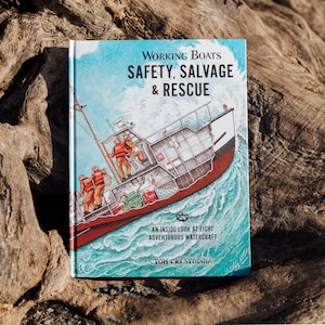 May include: A hardcover book titled "Working Boats: Safety, Salvage & Rescue" featuring an illustration of a rescue boat at sea. The book cover has a blue sky background and the text "An Inside Look at Eight Adventurous Watercraft" and the author's name.