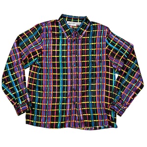 May include: A long-sleeved shirt with a colourful plaid design. The shirt has a black background with intersecting lines in blue, green, yellow, pink, and purple. The collar and cuffs are visible, and the shirt appears to be made of a silky material.