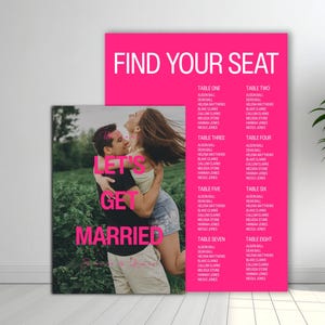 May include: Two wedding signs. One features a couple embracing with the text "LET'S GET MARRIED" in pink. The other sign is bright pink with the words "FIND YOUR SEAT" and a list of names under table numbers.