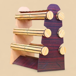May include: A wooden jewelry display stand with three horizontal bars for bracelets. The stand features a dark reddish-brown back and base with light wood-colored bars and circular accents. The design is simple and functional, suitable for showcasing jewelry.