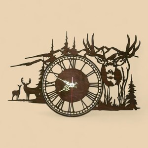 May include: A wooden wall clock featuring a deer and mountain scene. The clock has a dark brown face with Roman numerals and ornate hands. The surrounding design includes silhouettes of trees, mountains, and deer, creating a rustic aesthetic.