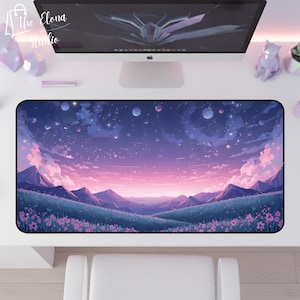 May include: A rectangular desk mat featuring a dreamy landscape design. The mat showcases a purple and pink sky with mountains, clouds, and a field of flowers. The Elona Studio logo is in the top left corner.