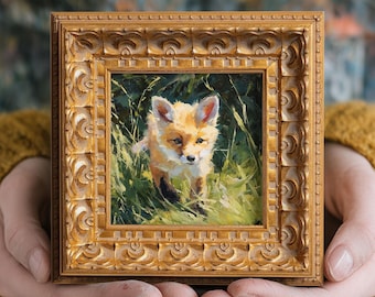 May include: A small, square, framed painting of a fox cub in a grassy field. The painting has a gold ornate frame. The fox has orange and white fur and is looking forward. The background is green and brown.