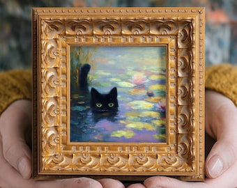 May include: A small square painting in an ornate gold frame depicting a black cat with bright green eyes swimming in a pond filled with colorful lily pads and water lilies. The artwork features visible brushstrokes and vibrant colors.