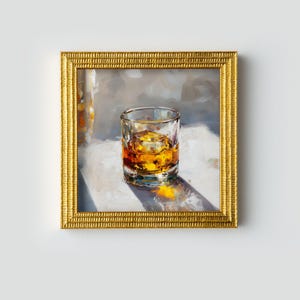 May include: A framed painting depicting a glass of whiskey with ice. The amber liquid is in a clear glass, set on a white surface. The painting is in a gold frame, with a soft, neutral background.