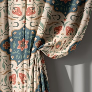 May include: Curtains with a repeating floral pattern in shades of cream, teal, and coral. The design features stylized flowers and leaves within a geometric border. The fabric is draped, showing the texture and folds of the material.
