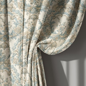 May include: Cream-colored curtain with a repeating floral pattern in shades of blue and tan. The fabric is draped, revealing the intricate design of the curtain. The curtain is made of a textured material.