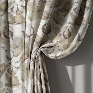 May include: Curtains with a floral pattern featuring beige and brown hydrangea blooms and buds. The fabric has a textured appearance, with the curtains partially draped, revealing the pattern and texture.