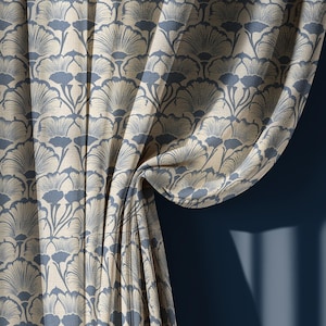 May include: Curtains with a repeating pattern of stylized blue and beige fan-shaped designs. The fabric is draped, revealing the texture and pattern. The background is a solid dark blue wall with shadows.