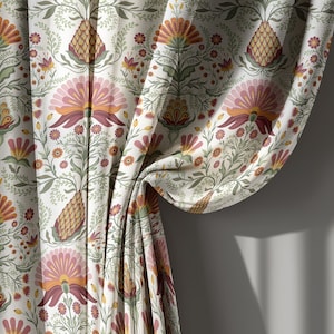 May include: Cream-colored curtain fabric with a repeating floral pattern. The design features stylized flowers in shades of pink, orange, and burgundy, along with green leaves and pineapple motifs. The curtain is draped, revealing the pattern's intricate details.