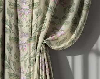 May include: Curtain fabric with a floral pattern. The design features pink and white flowers with green leaves on a beige background. The fabric is draped, showing the texture and folds of the material.
