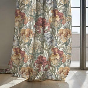 May include: Floral patterned curtain featuring large iris flowers in shades of red, yellow, and blue against a cream background. The curtain is hanging in front of a window with a wooden floor.