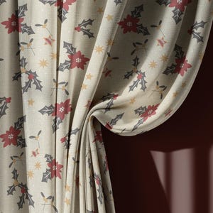 May include: Cream-colored curtain fabric with a repeating pattern of red poinsettias, gray holly leaves, and gold stars. The fabric is draped, showing folds and texture, with a glimpse of a dark red wall in the background.
