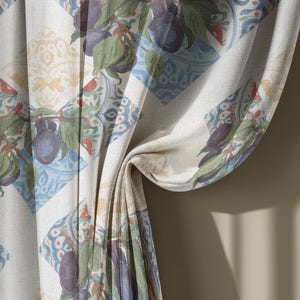 May include: A curtain panel featuring a repeating diamond pattern on a light background. Each diamond contains illustrations of dark purple plums with green leaves and intricate blue and orange decorative motifs, creating a textured visual effect.