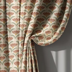 May include: Curtain panel with a repeating floral pattern. The design features stylized flowers in shades of rust, sage green, and yellow on a cream background. The fabric is draped, showing the pattern's flow and texture. The curtain is against a neutral gray wall.