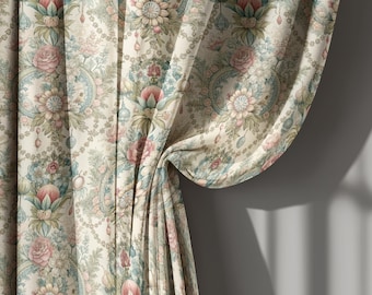 May include: Curtains with a floral pattern in shades of cream, pink, and blue. The fabric features a repeating design of roses, flowers, and decorative elements. The curtains are draped, showing the texture and folds of the material.