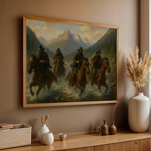Könnte beinhalten: Gerahmtes Gemälde mit Western-Thema, das vier Cowboys auf Pferden zeigt, die einen Fluss überqueren. Das Kunstwerk zeigt einen Berg-Hintergrund und eine natürliche Farbpalette, wobei die Cowboys Hüte und dunkle Kleidung tragen.