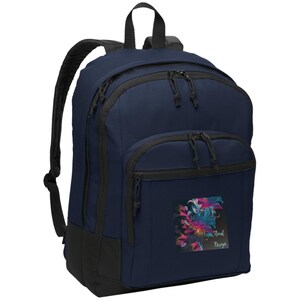 May include: Navy blue backpack with black trim and zips. The backpack has a square patch with a colourful floral design and the text "Floral Designs" in white script. Includes a top handle and adjustable shoulder straps.