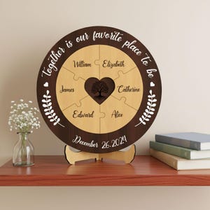 May include: A personalized wooden puzzle with the text "Together is our favorite place to be." The puzzle features names and a heart-shaped tree design. The date "December 26.2024" is also displayed.