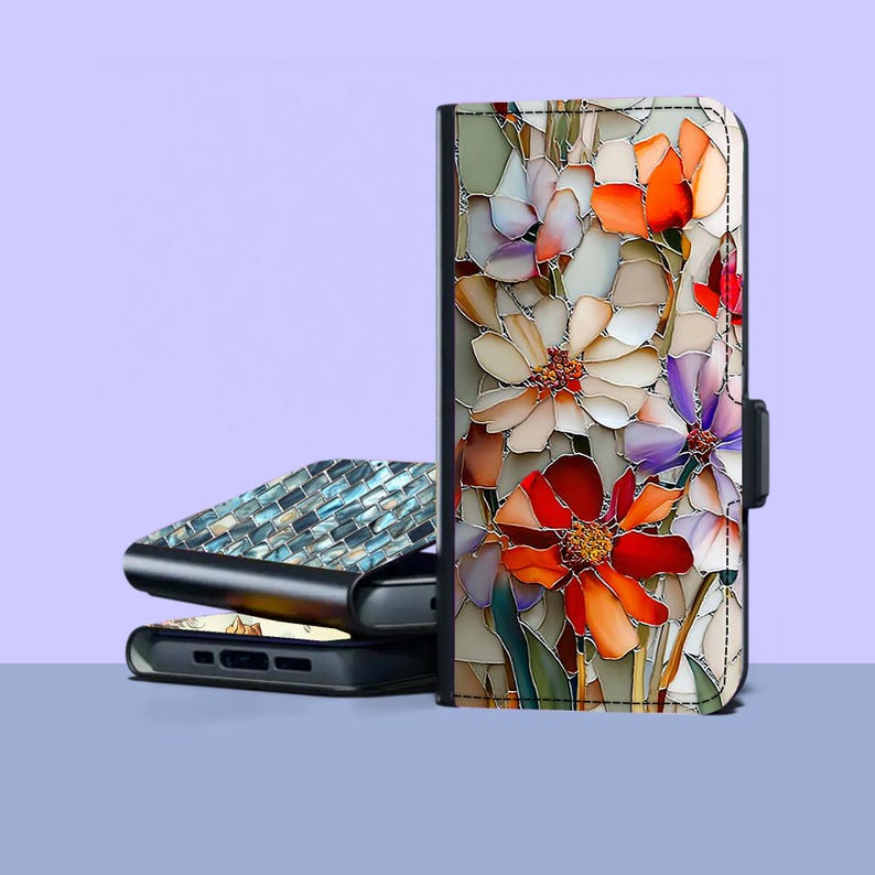 May include: A floral phone case with a stained glass effect. The case features a vibrant design of red, orange, white, and purple flowers. A second phone case with a mosaic tile design is visible in the background.
