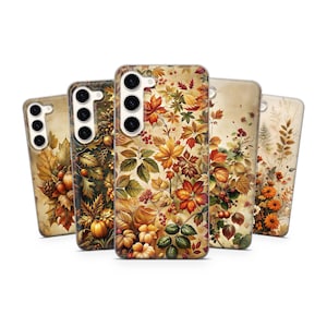 May include: Five rectangular smartphone cases arranged in a row, each featuring a distinct autumn-themed pattern with vibrant orange, yellow, red, and brown leaves, berries, pumpkins, and floral elements against a light cream-colored background.