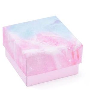 May include: A square gift box with a pastel watercolor design. The lid features a blend of pink, blue, and white hues, resembling a marble or galaxy pattern. The box's base is a solid light pink color.