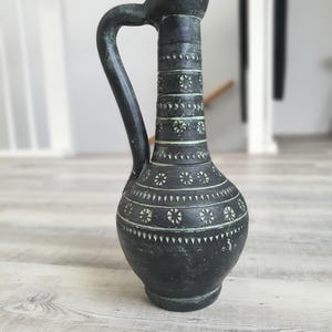 Black ceramic antique vase with handpainted decorations