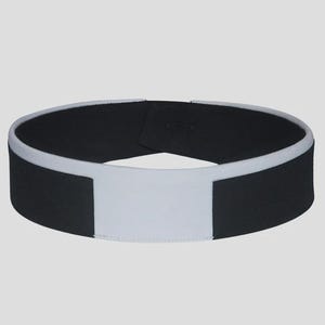 May include: A black and white collar with a hook and loop closure. The collar has a white rectangular front and a white trim around the black band. The collar is designed to be worn around the neck.