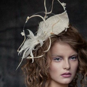 Hat, fascinator, bridal head piece in ivory with floaty detail and feathers