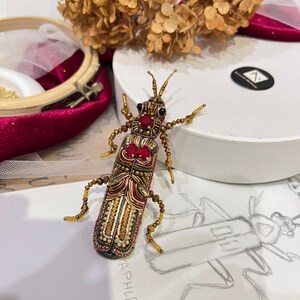 Handcrafted Beaded Bug Brooch with Red Gems and Gold Accents