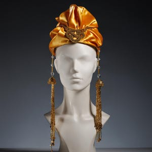 Golden satin turban with ornate brooch, regal headpiece, luxury formal hair accessory