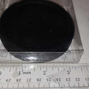 May include: A black round foam pad in a clear plastic package. The pad is about 1 inch in diameter.