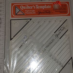 May include: A white plastic quilting template with a black border and markings for right angle triangles. The template is labeled "Quilter's Template Right Angle Triangles by Yours Truly, Inc." and includes measurements in inches from 1/2 inch to 4 1/2 inches.