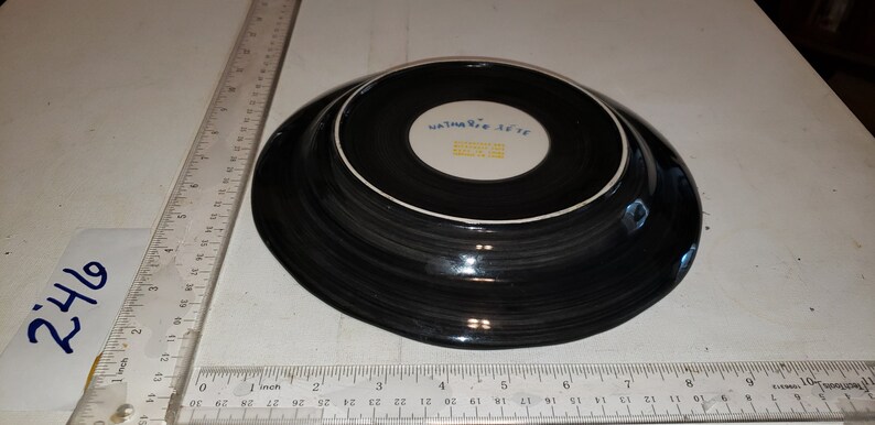 May include: Black and white ceramic plate with a blue and white logo that reads "Waterford  X-cite  Made in China".