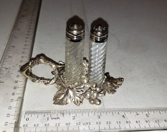 Salt and Pepper shakers in metal holder excellent condition