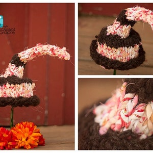 May include: A brown and pink crocheted hat with a long pointed top. The hat is made from a variety of fabrics and yarns, including brown, pink, and white.