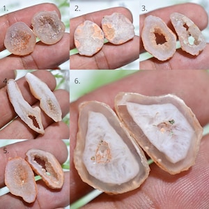 May include: A collection of six pairs of polished agate geodes, each showcasing unique internal crystal formations and color variations. The geodes range in size and shape, with a mix of white, orange, and translucent hues. The rough outer edges contrast with the smooth, polished interiors.