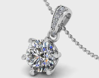 May include: A sparkling diamond pendant necklace. The pendant features a large, round-cut diamond held in a six-prong setting. The bail is adorned with smaller accent diamonds. The necklace chain is a delicate silver color.