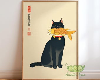 May include: A framed print featuring a black cat holding a golden fish in its mouth. The cat wears a red collar with a bell. Japanese text is on the left side of the print. The background is a light beige color.